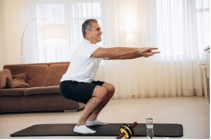 Man in 50's doing deep squat.